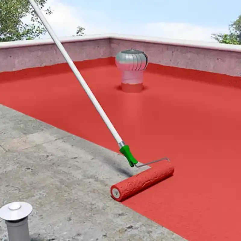 Rodillo aplicando impermeabilizante acrílico rojo sobre la azotea de un edificio en proceso de impermeabilización. Se observan respiraderos y un trabajo en progreso que asegura la máxima durabilidad y protección contra filtraciones en techos planos.